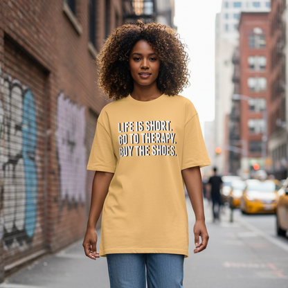 Person wearing a yellow t-shirt with text walking on a city street.